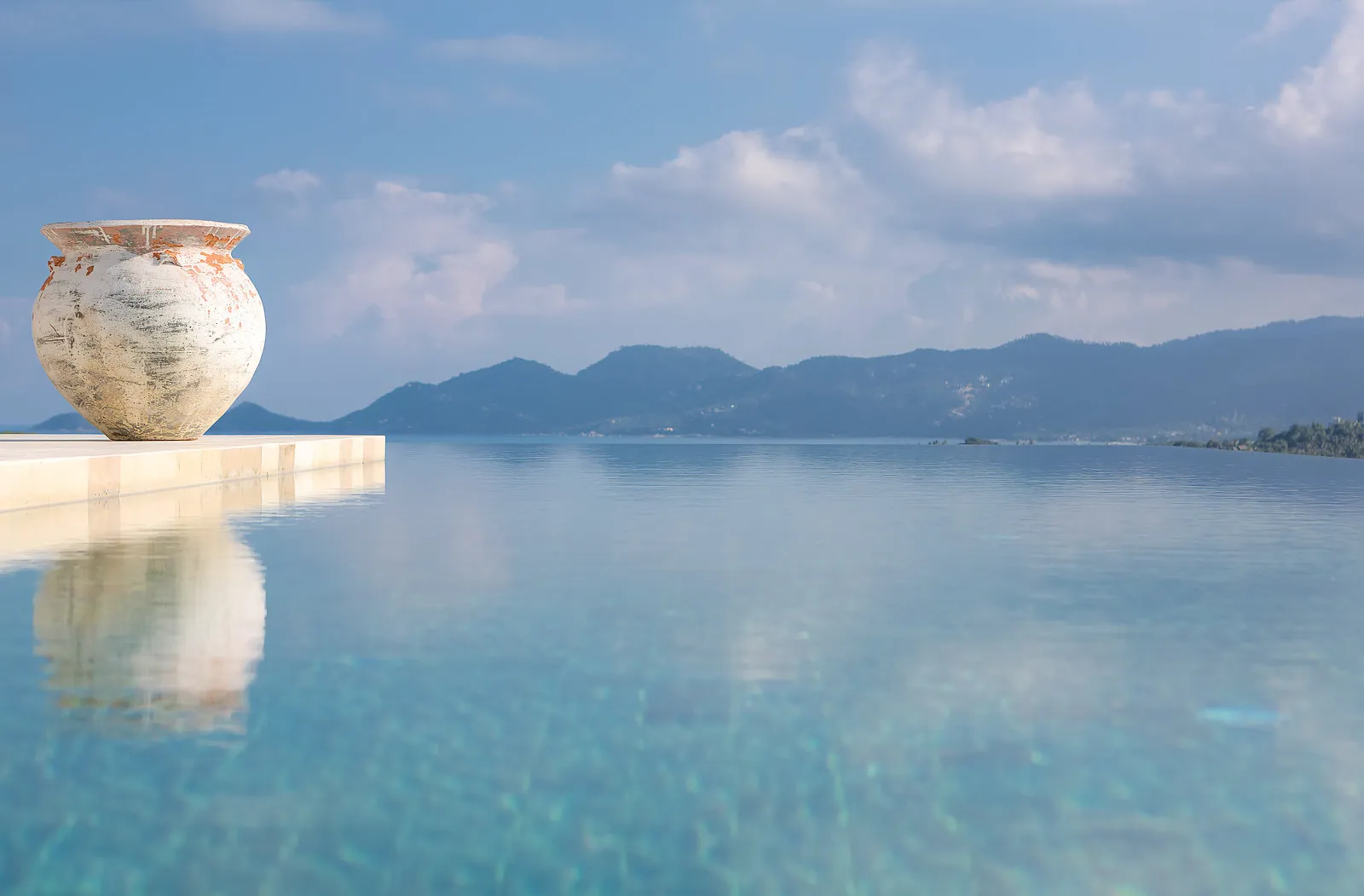Infinity pool with clay pot and panoramic mountain vista, Koh Samui
