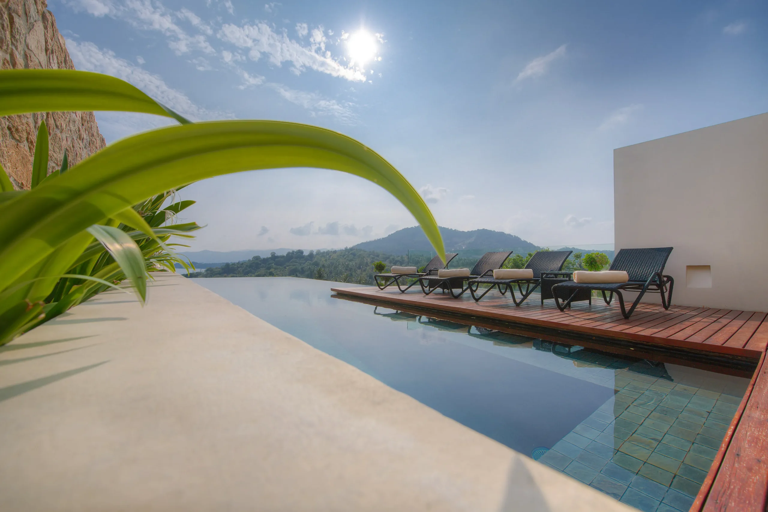 Teak infinity pool deck with coastal horizon, Koh Samui