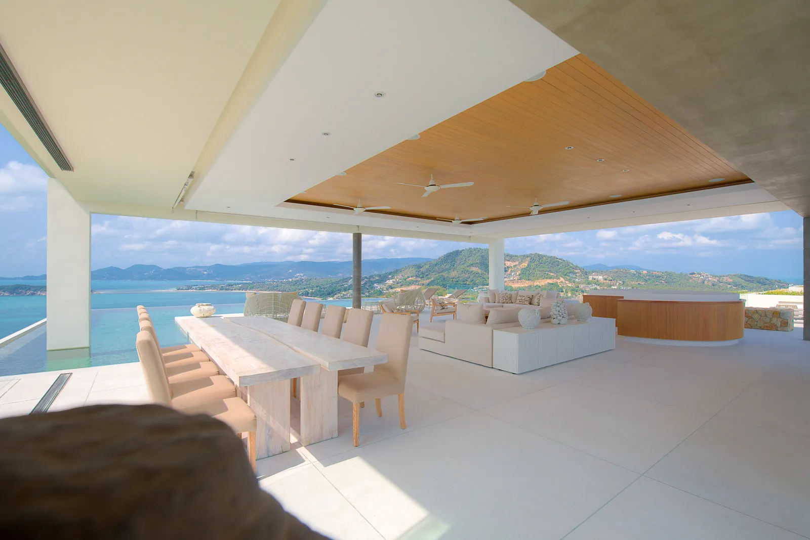 Open-plan dining and lounge terrace overlooking turquoise bay, Koh Samui