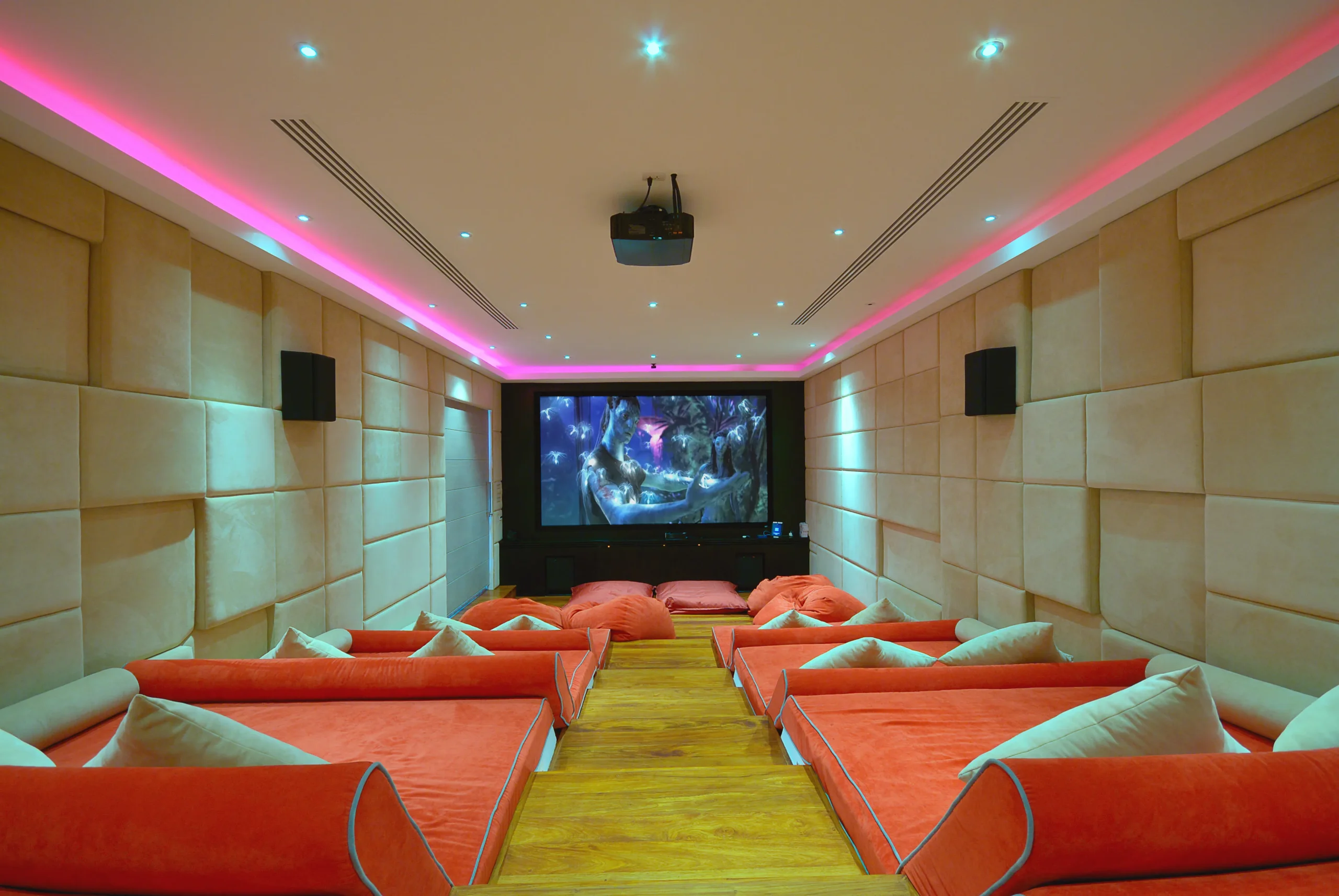 Private cinema room with orange seating and ambient lighting in a Koh Samui villa