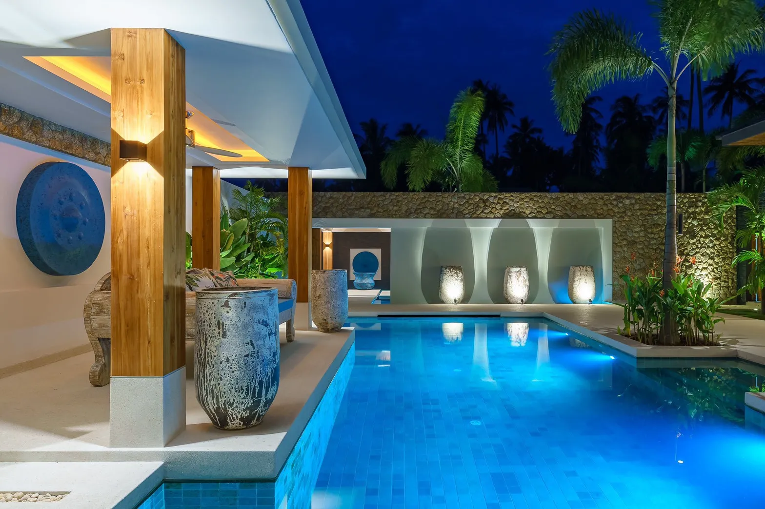 Illuminated courtyard pool at luxury villa at night, Koh Samui