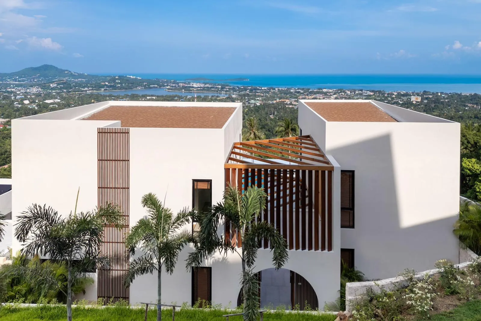 Hillside exterior overlooking white modern villa with bay view, Choeng Mon, Koh Samui